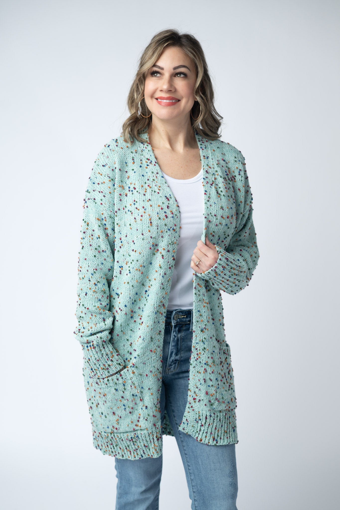 Women's confetti dot cardigan in Aqua Blue with colorful confetti speckles, open front, front pockets, and ribbed trim