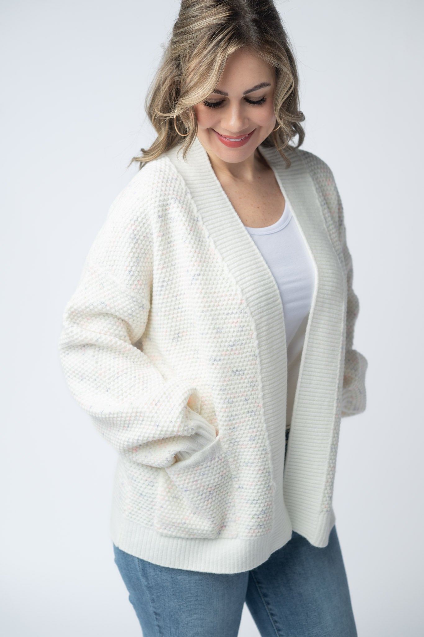 Women's open front cardigan in Purple, Pink, and Green Mix with cream base, textured knit, front pockets, and relaxed fit