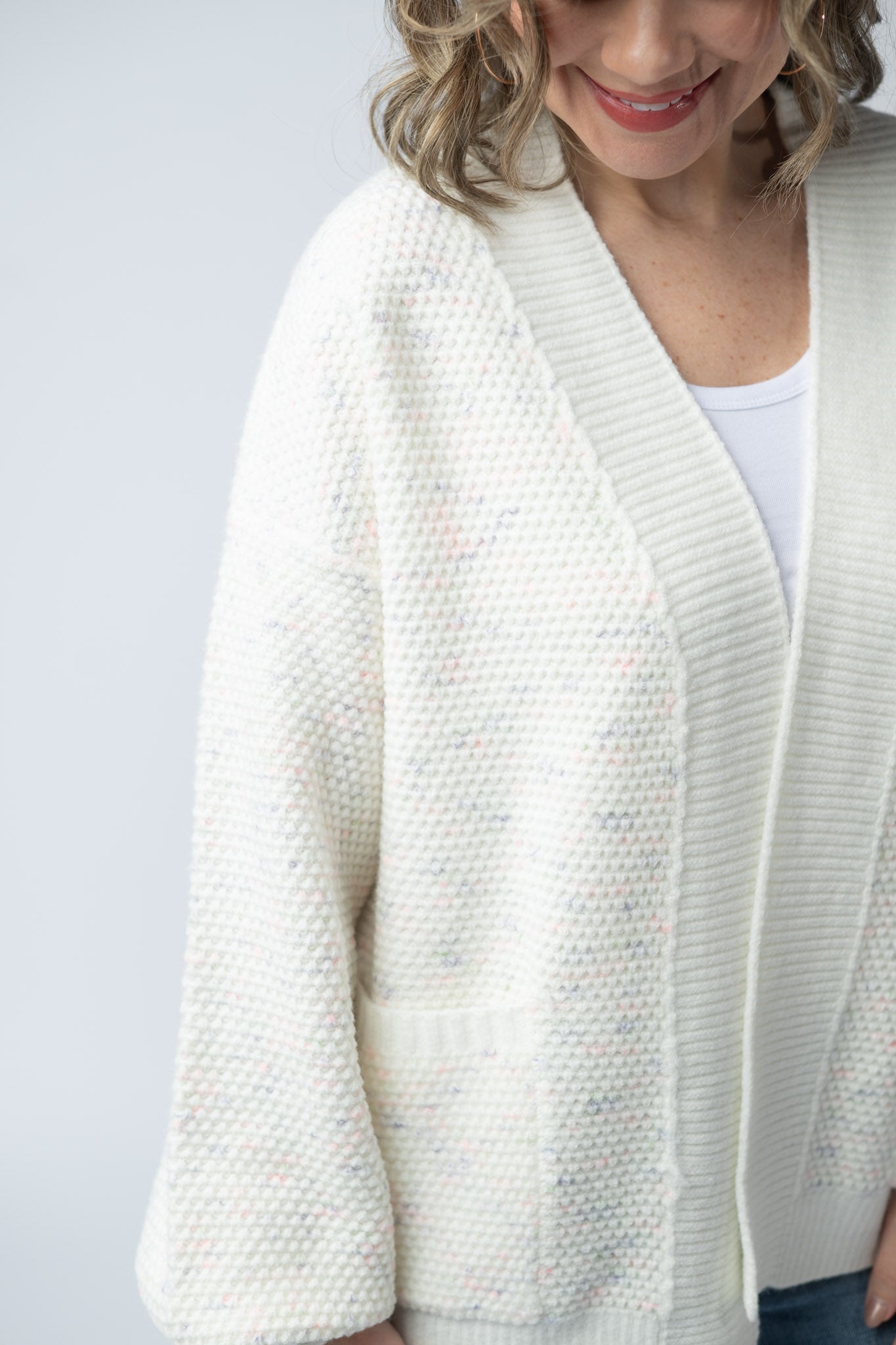 Women's open front cardigan in Purple, Pink, and Green Mix with cream base, textured knit, front pockets, and relaxed fit