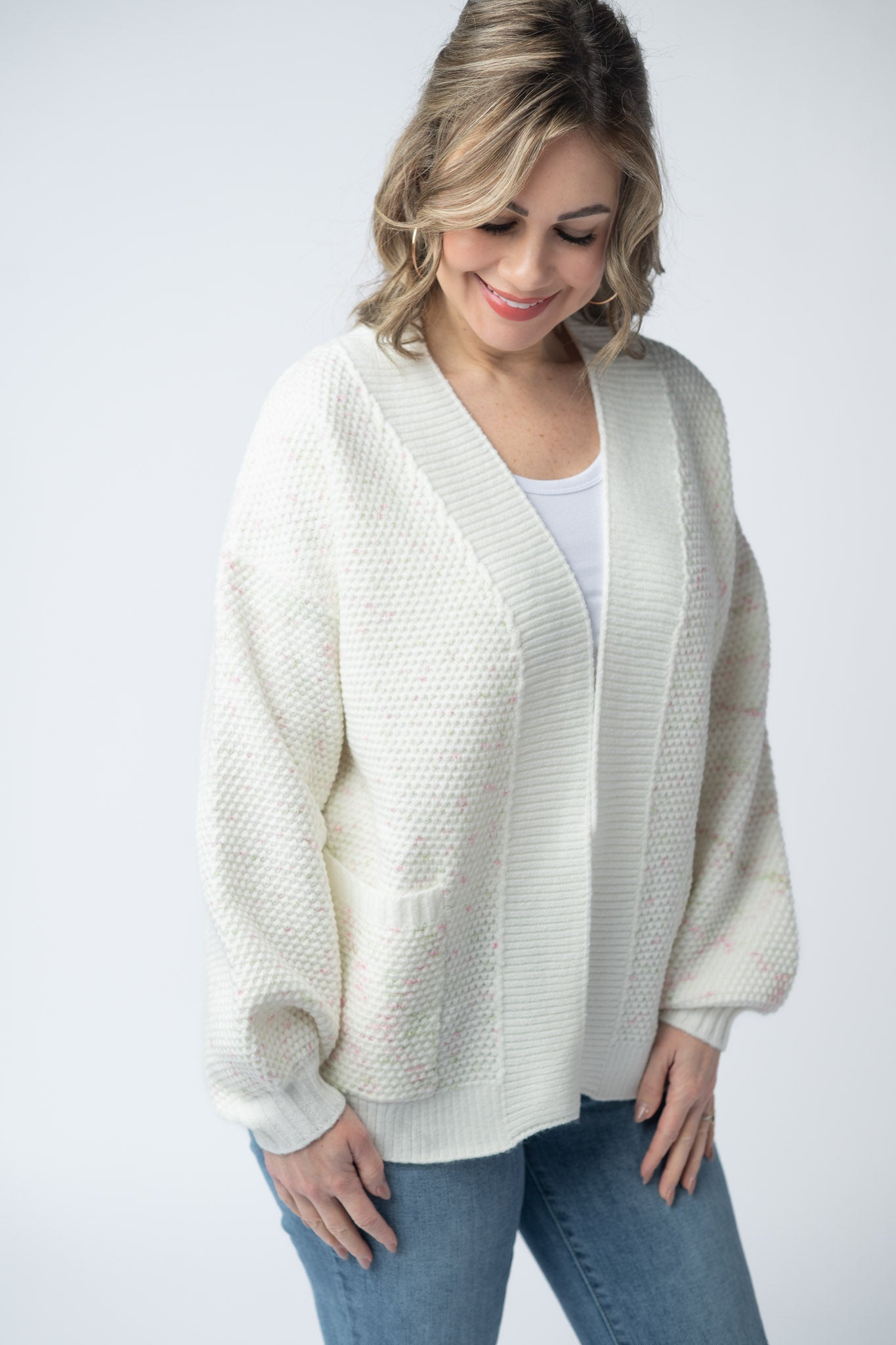 Women's open front cardigan in Pink and Green Mix with cream base, textured knit, front pockets, and relaxed fit