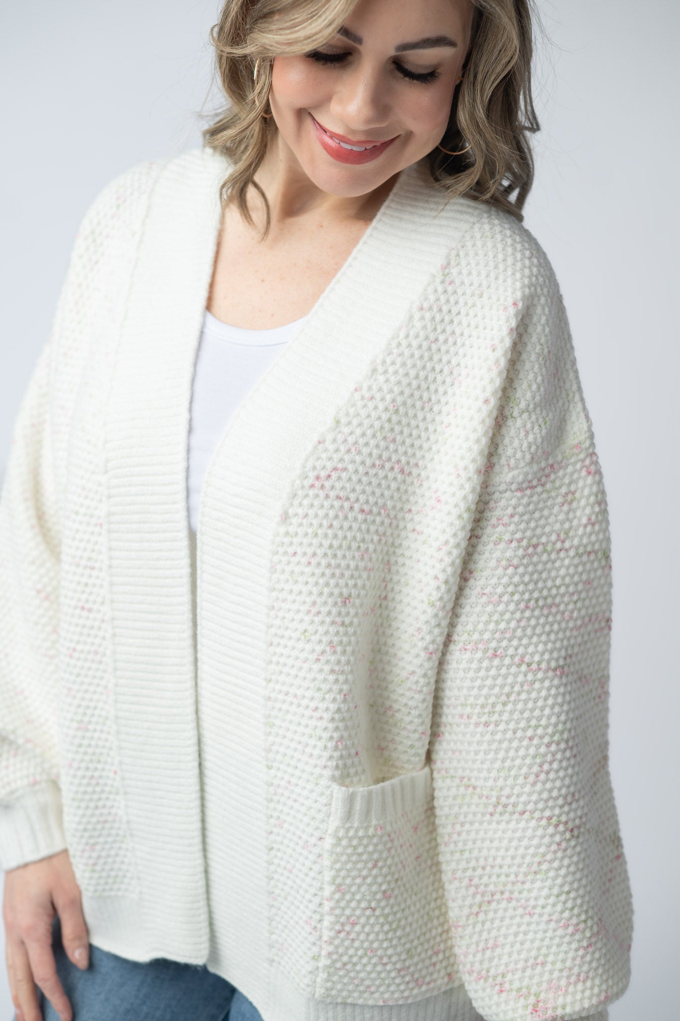 Women's open front cardigan in Pink and Green Mix with cream base, textured knit, front pockets, and relaxed fit