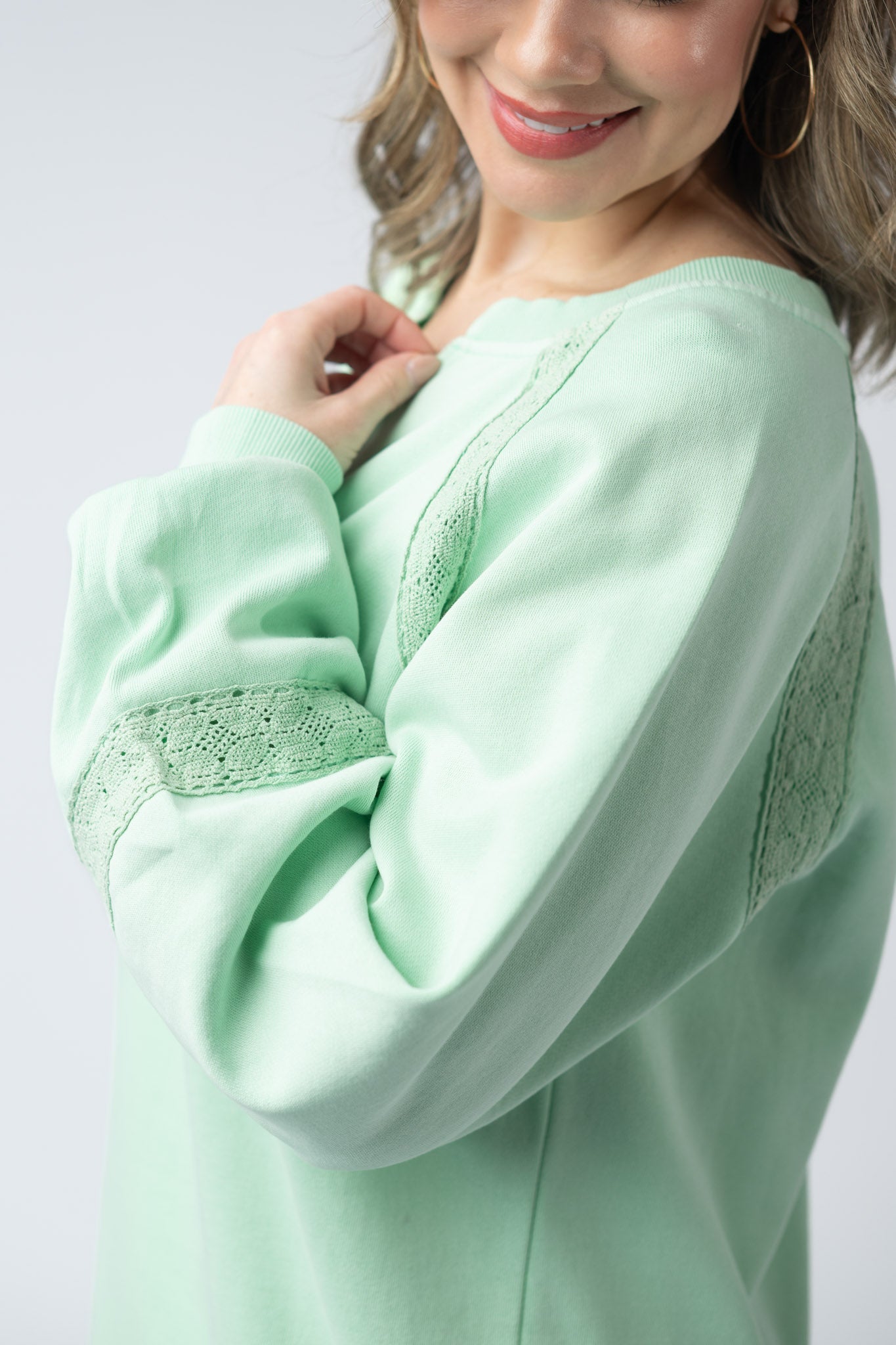 Women's lace accent vintage wash pullover in Mint with notch neckline, lace shoulder and sleeve details, and relaxed fit