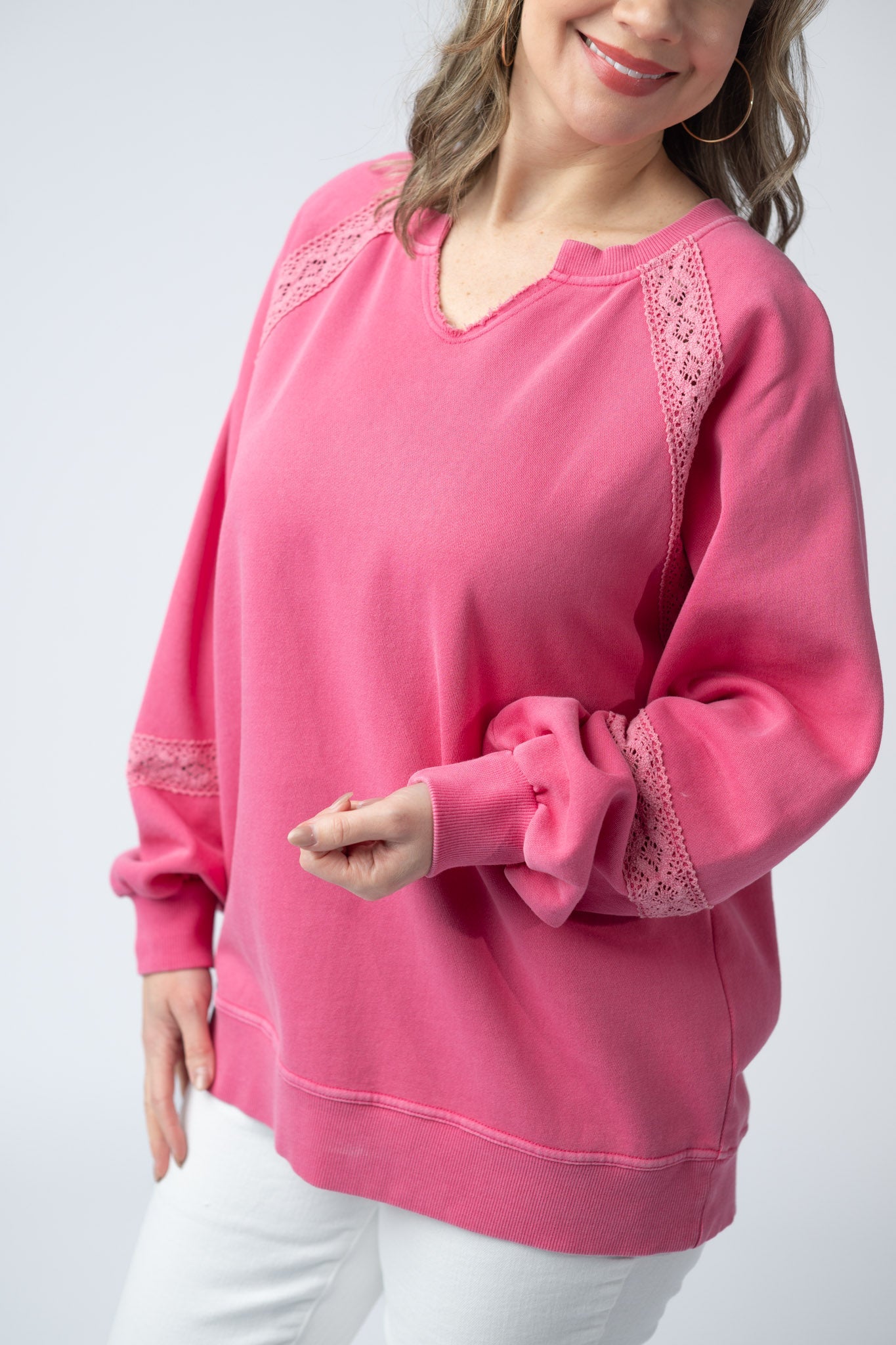 Women's lace accent vintage wash pullover in Hot Pink with notch neckline, lace shoulder and sleeve details, and relaxed fit