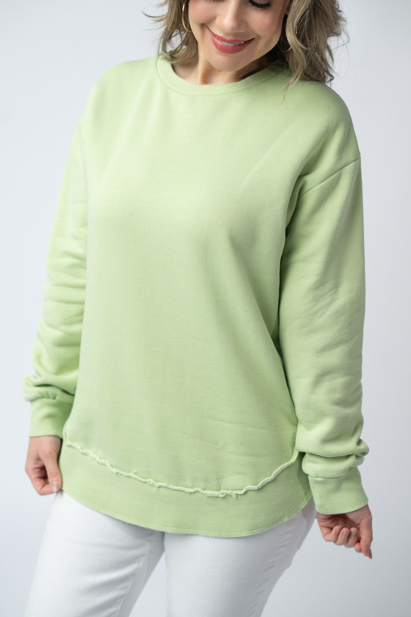 Women's vintage wash pullover in Spring Leaf with crew neck, relaxed fit, and raw edge hem details