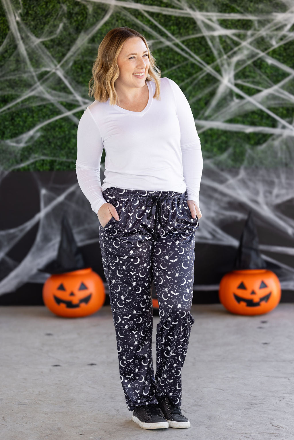 Midnight Bats lounge pants with pockets, stretch waist, and drawstring. Soft, true-to-size black and white Halloween favorite.