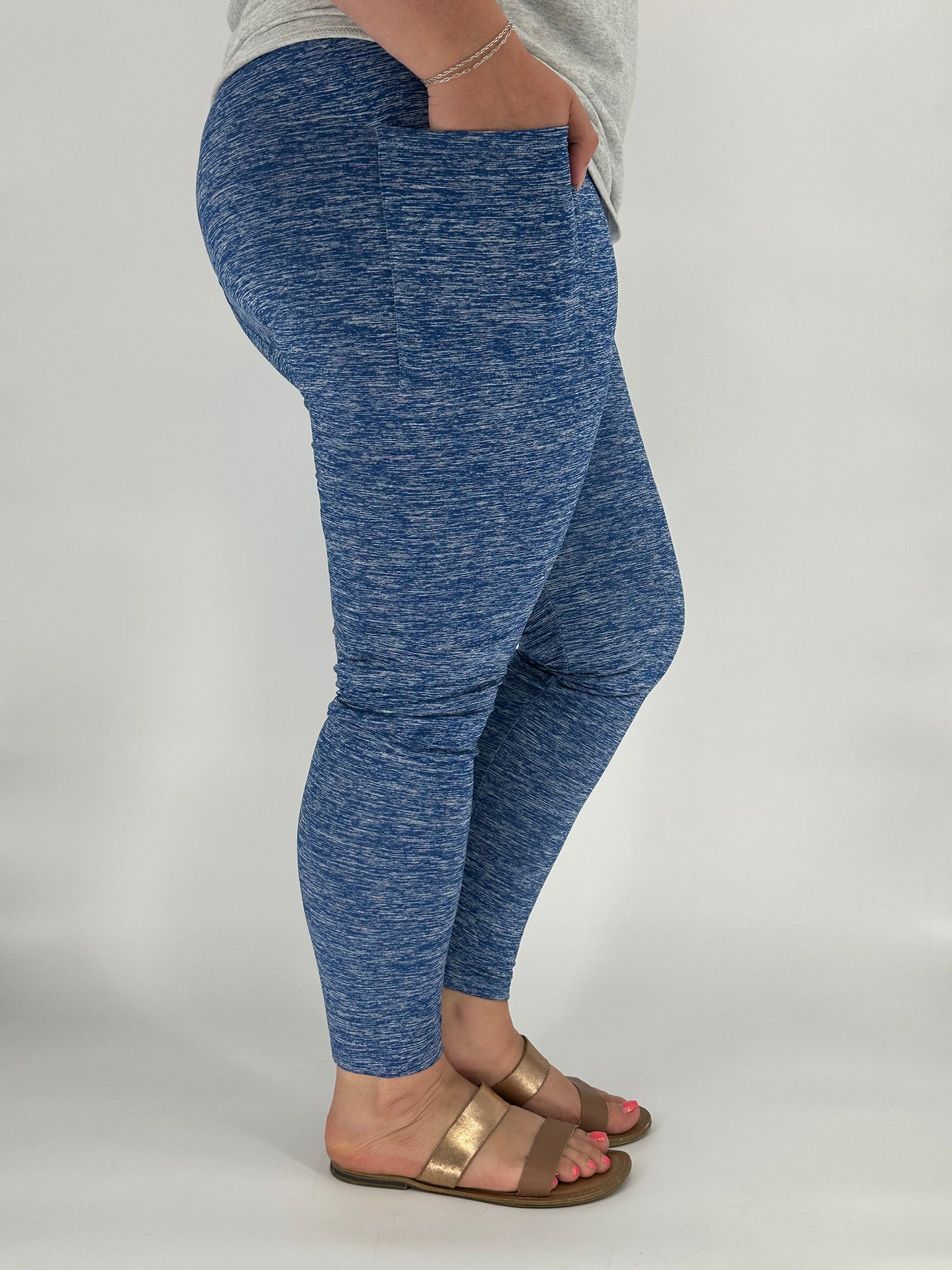 Model wearing heathered royal blue fleece-lined leggings with side pockets