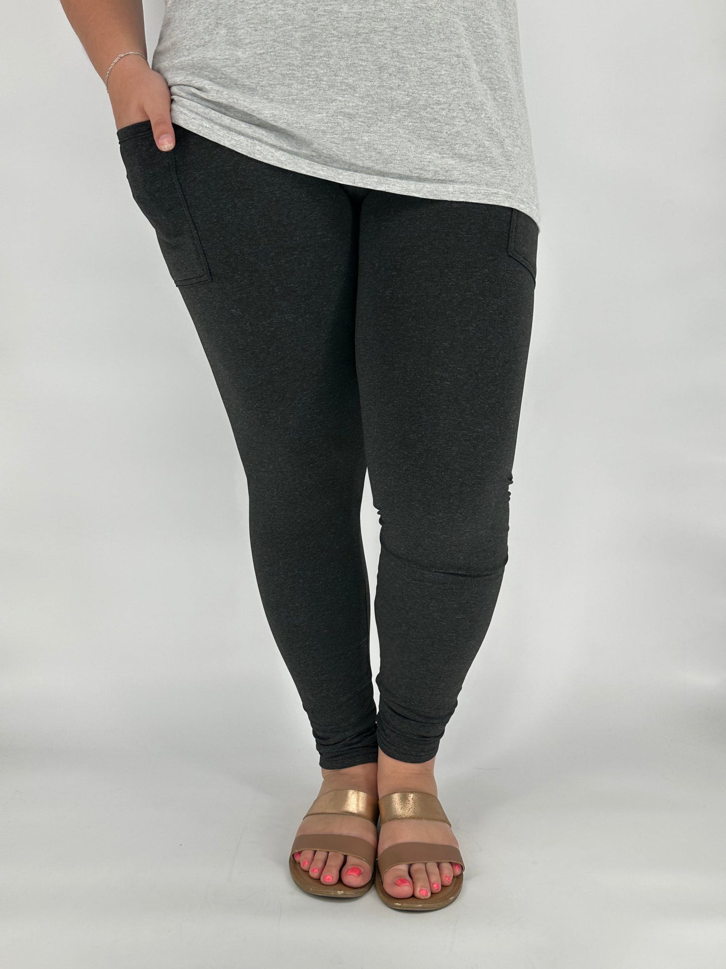 Model wearing heathered black fleece-lined leggings with side pockets
