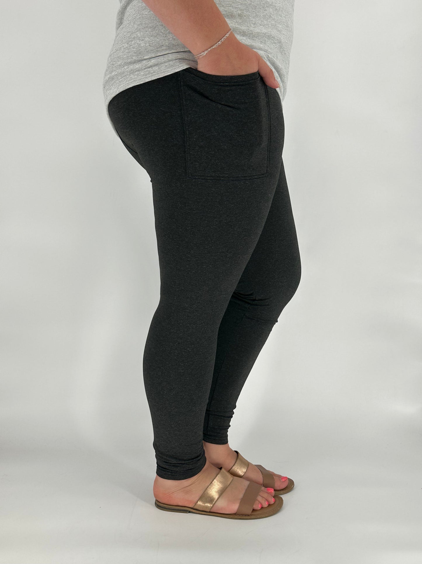 Model wearing heathered black fleece-lined leggings with side pockets