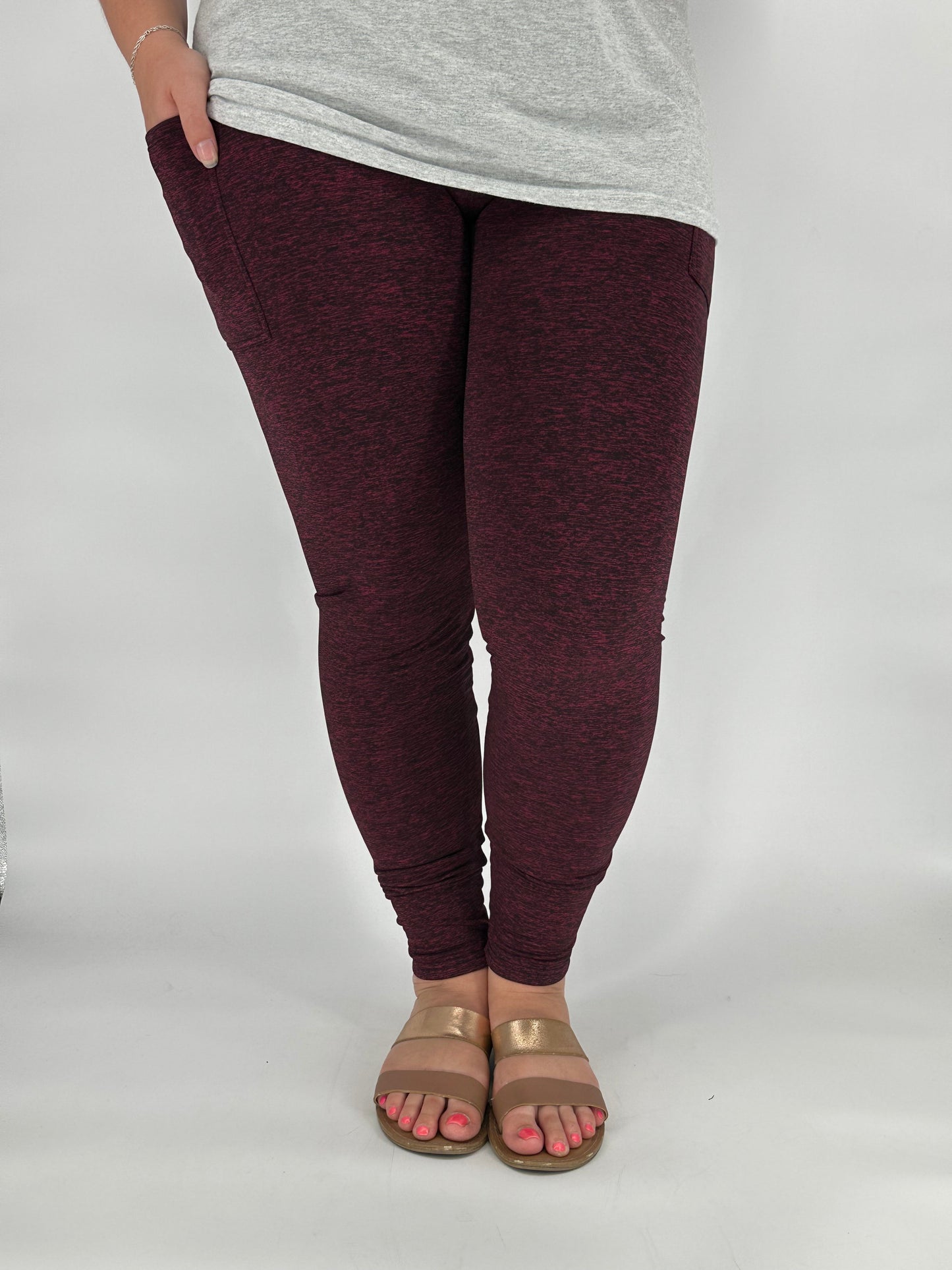 Model wearing heathered maroon fleece-lined leggings with side pockets