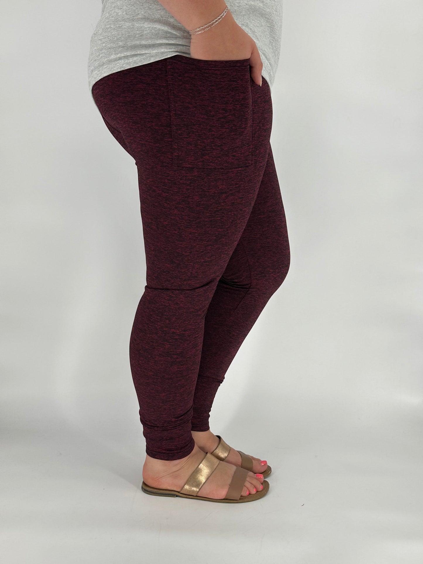 Model wearing heathered maroon fleece-lined leggings with side pockets