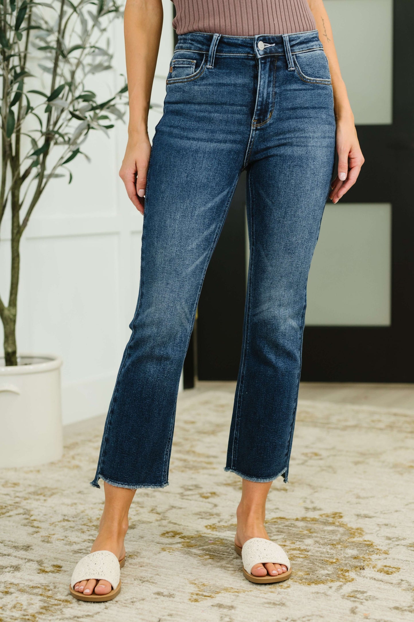 Model wearing Nova high waist kick flare jeans with frayed stepped hem