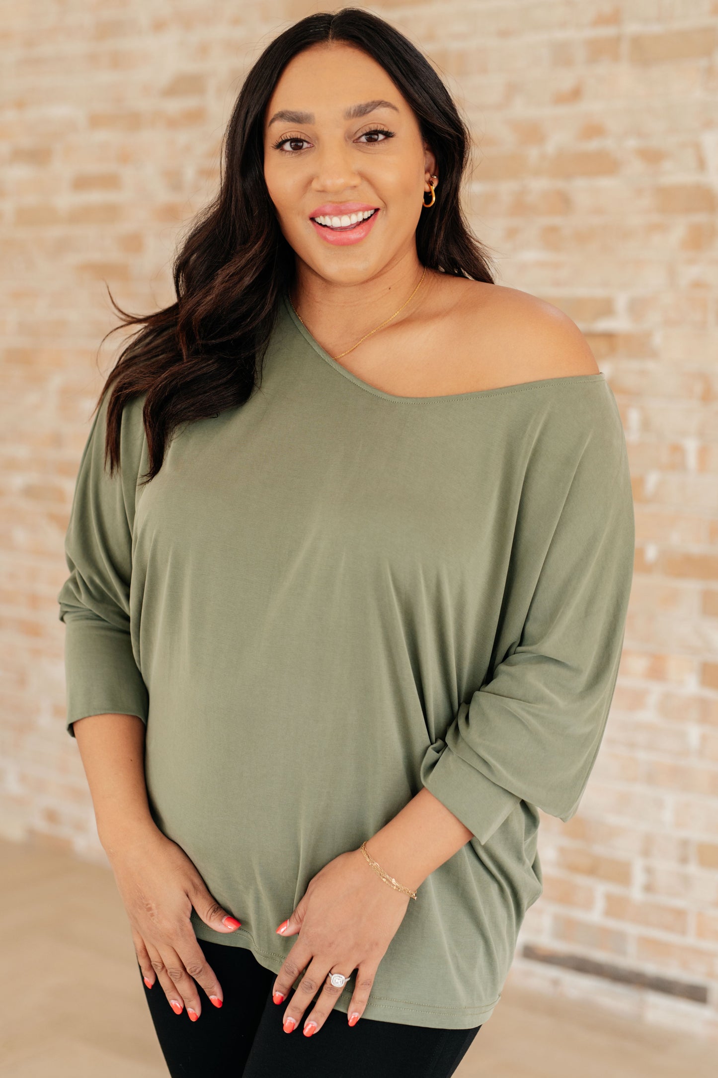 Model wearing olive green My Cozy Haven Long Sleeve Top with boat neckline and dolman sleeves