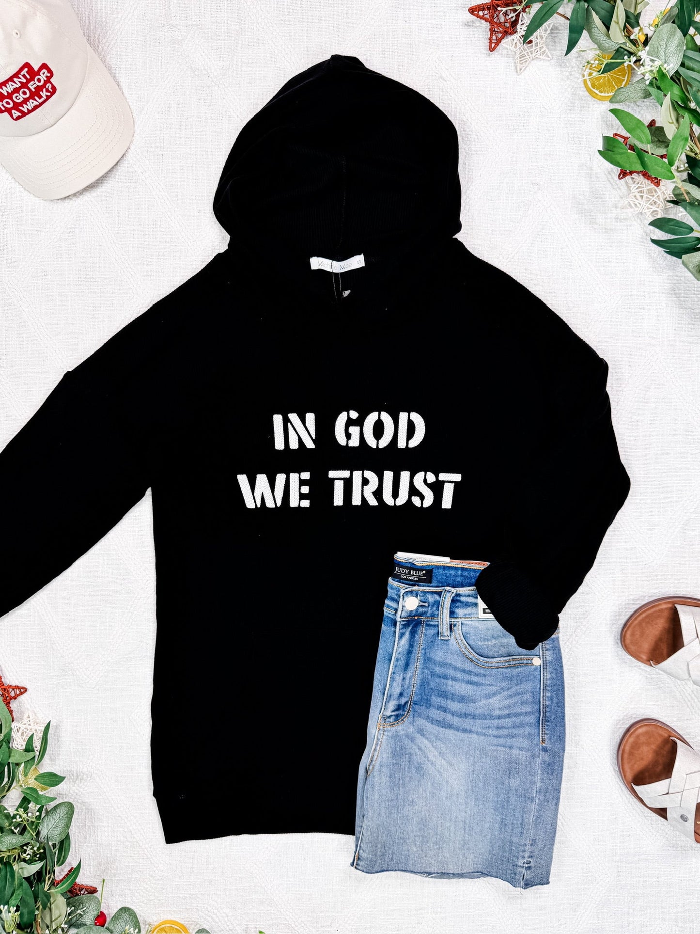 Corrine Embroidered Hoodie in black with “In God We Trust” design, kangaroo pocket, and cuff sleeves.
