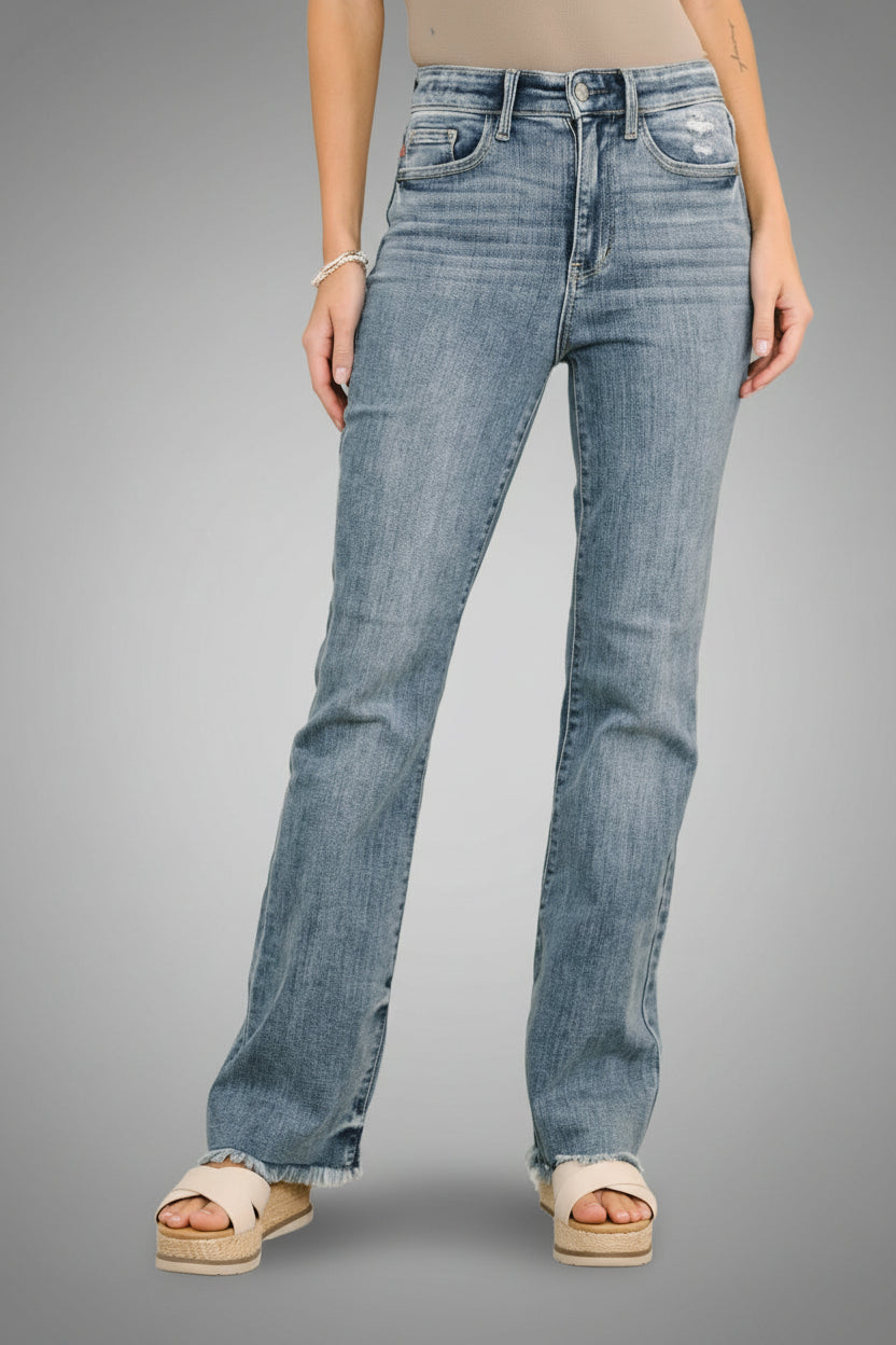 Woman wearing Robin light wash high waisted bootcut jeans with frayed hem and light distressing