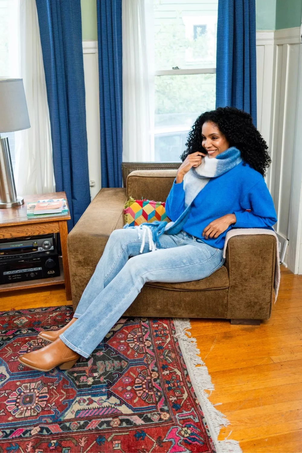 Woman wearing Aspen medium wash thermal bootcut jeans with mid-rise fit and slight flare at hem