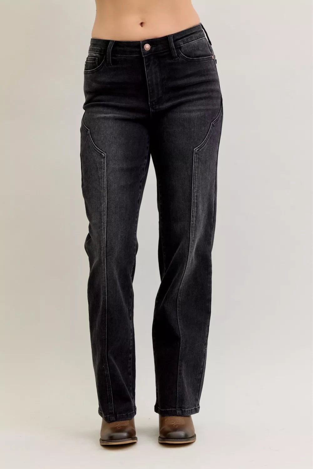 Woman wearing Oakley black straight leg jeans with distinctive western seam details down the front