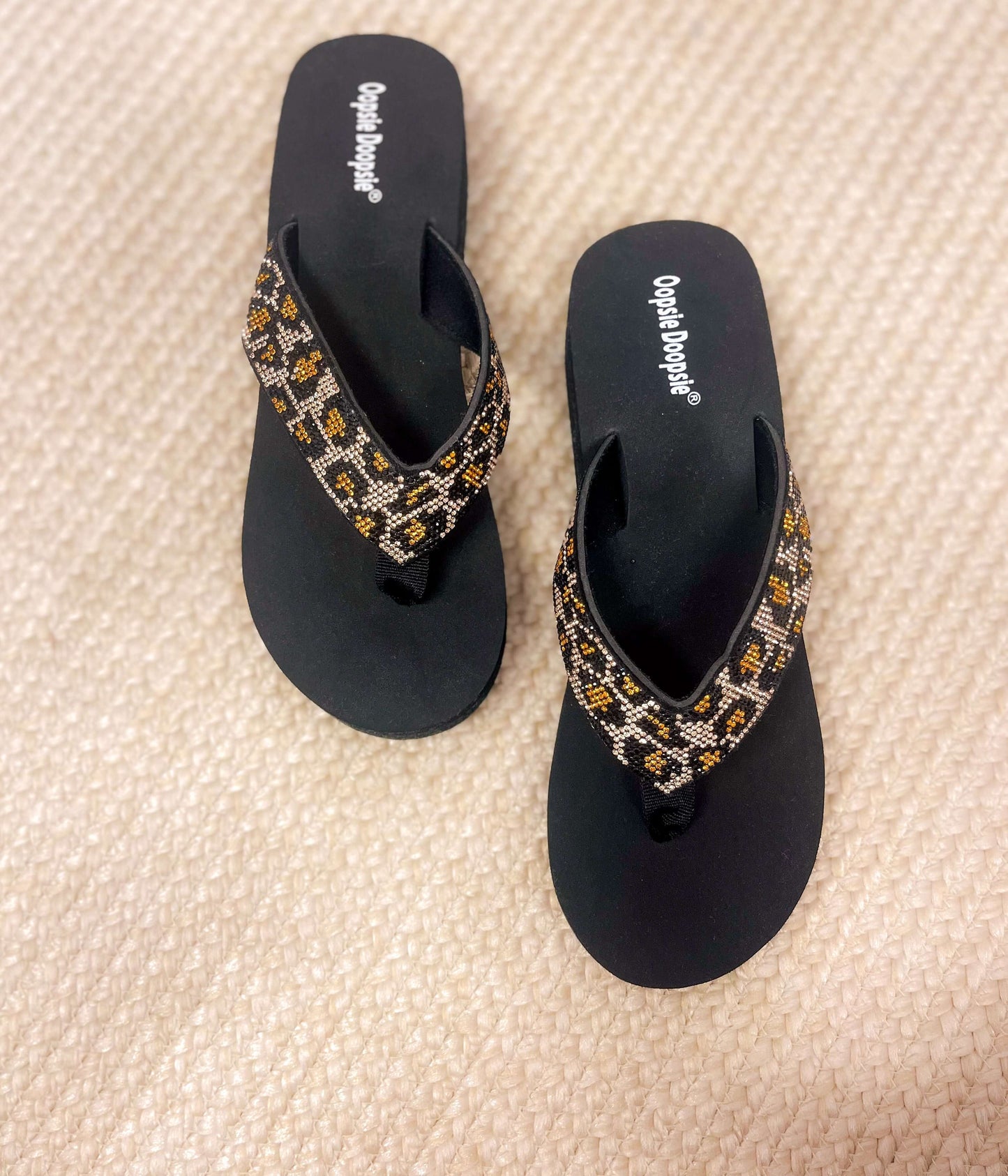 Cheetah rhinestone platform sandals with black base and beaded animal print straps