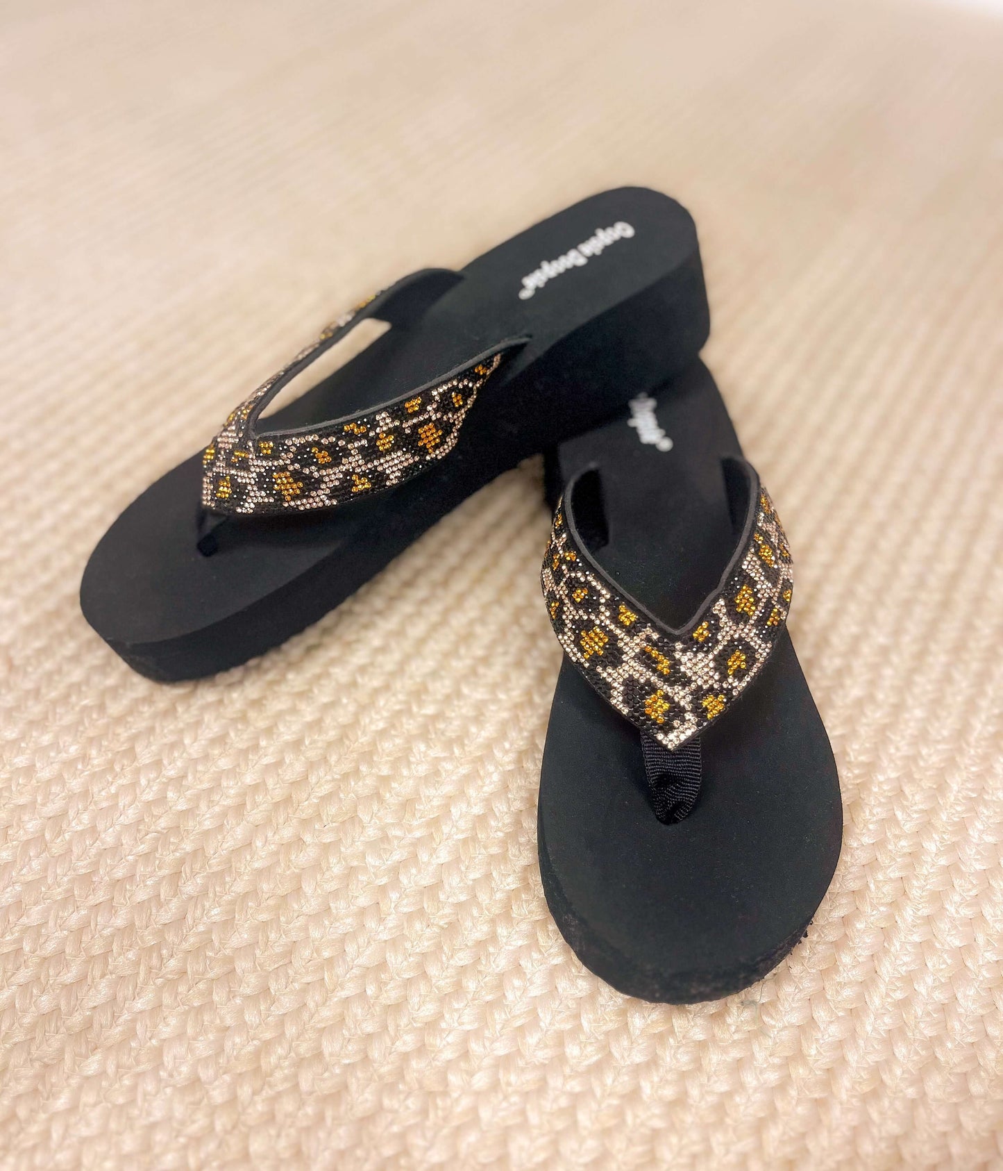 Cheetah rhinestone platform sandals with black base and beaded animal print straps