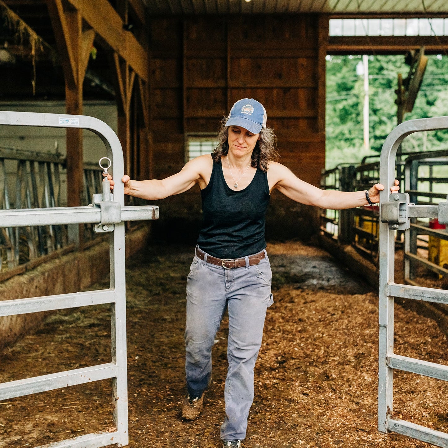 Woman wearing black Lafayette lightweight 100% merino wool tank top with scoop neck and princess seam detailing
