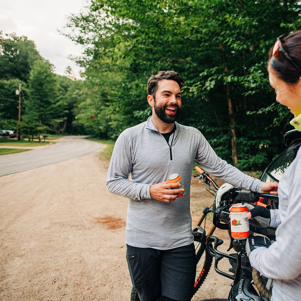 Man wearing Woolverino men's 1/4 zip merino wool base layer, enjoying drinks outdoors.