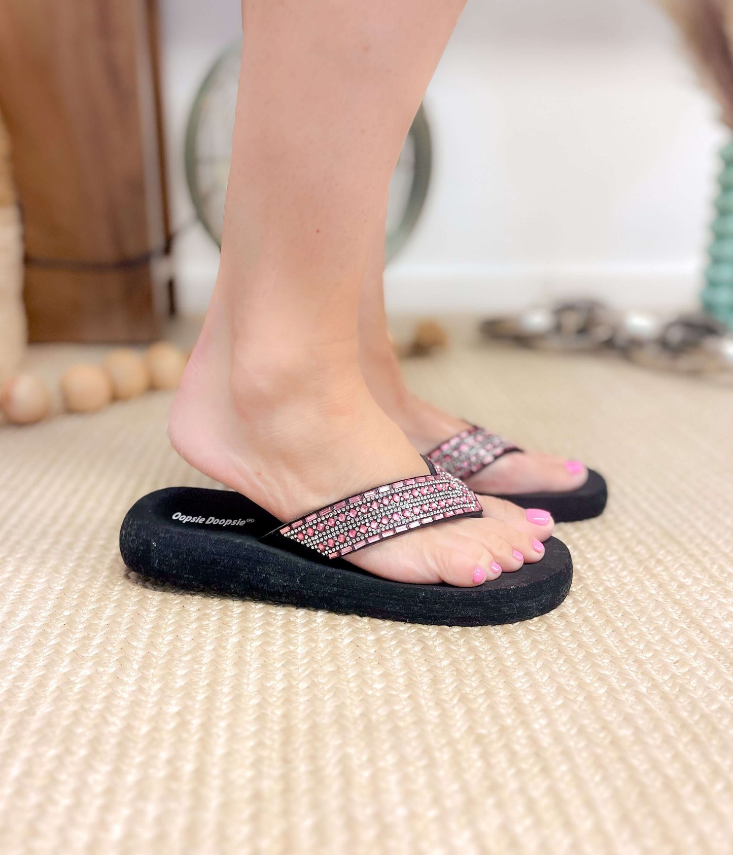 Model wearing fuchsia rhinestone platform sandals with V-strap and black sole